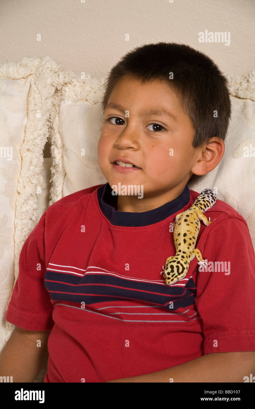Hispanic Boy 5-7 year years old  with leopard gecko pet United States America  MR  © Myrleen Pearson Stock Photo