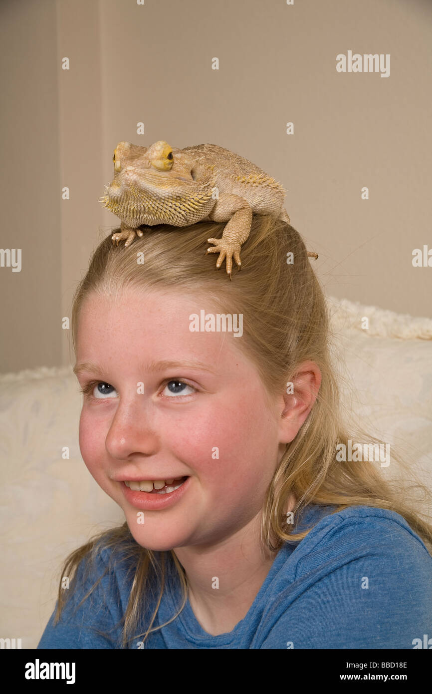 Portrait Young girl girls face 9-10 year olds bearded dragon color blending deception trick nature natural hiding concealing protection head matching Stock Photo