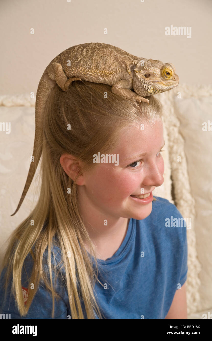 Portrait Young girl 9-11 year olds bearded dragon color blending deception trick nature natural hiding concealing protection head matching concealment Stock Photo