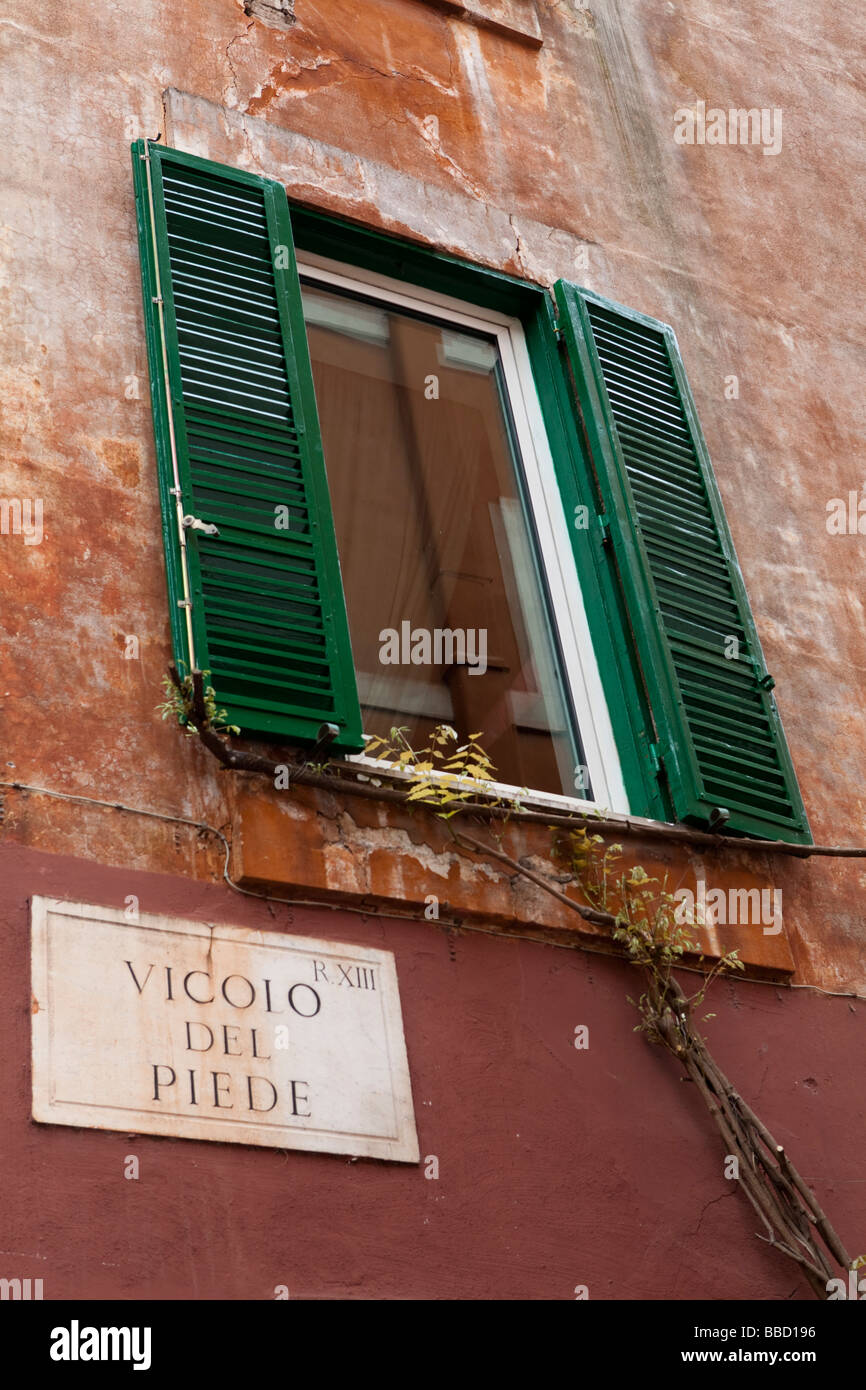 Window with Jalousie shutters and Street Sign, Vicolo del Piede near Piazza dei Renzi Stock Photo