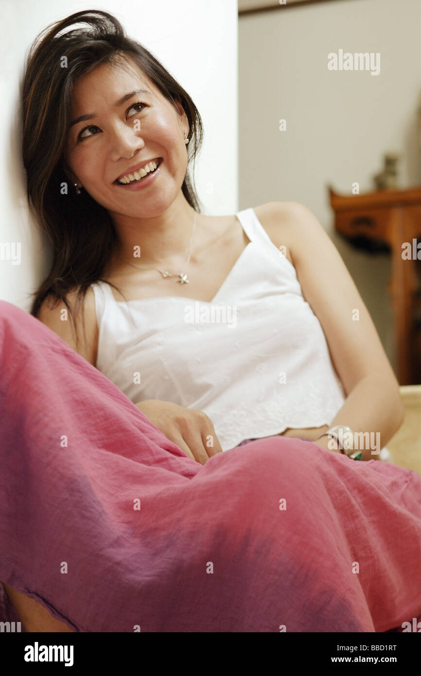 Woman looking upwards, portrait Stock Photo