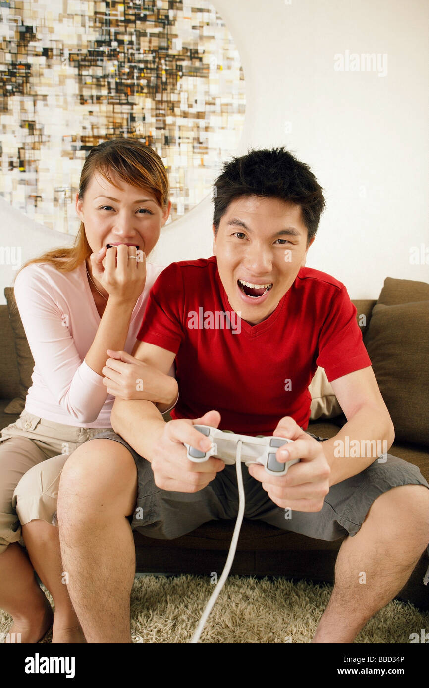 Couple at home, man holding game controller Stock Photo
