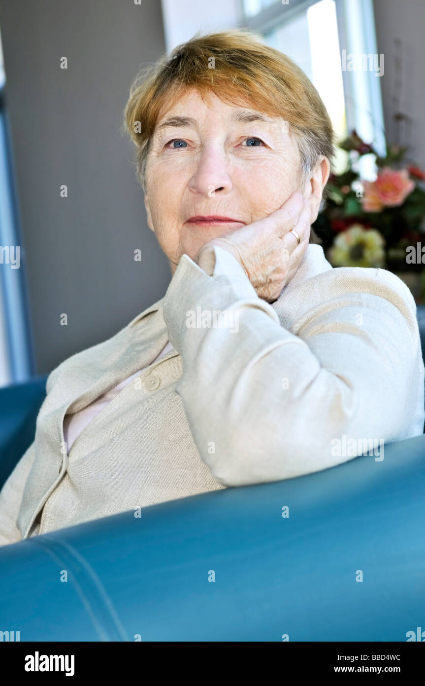 Elderly woman sitting in white linen jacket Stock Photo - Alamy