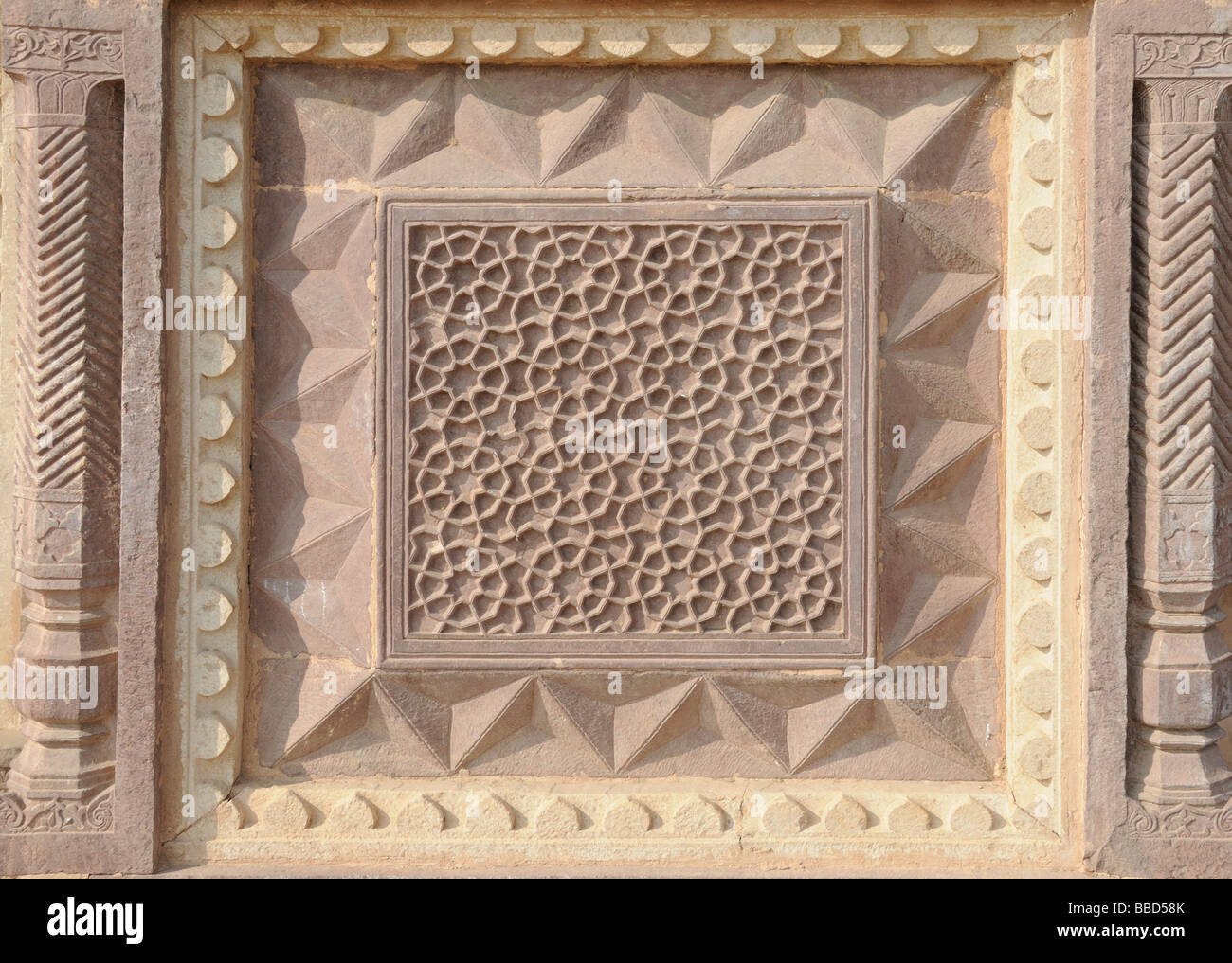 A decorative stone panel carved with pentagons, eight-pointed stars and other shapes. Jahangir Mahal (Palace) at Orchha. Stock Photo