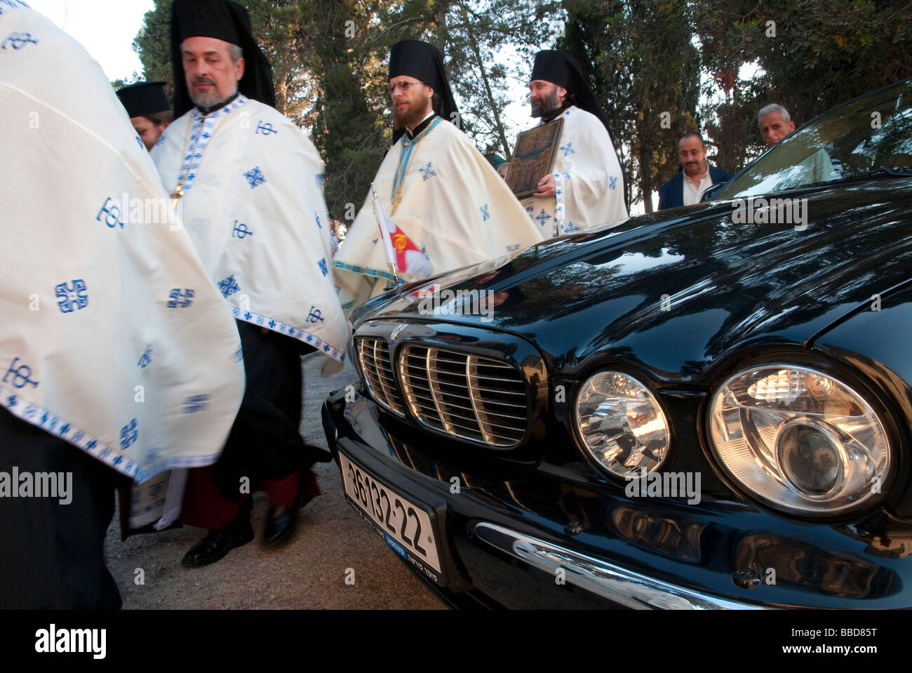 Israel Jerusalem Mount of Olives Orthodox procession passing next to Jaguar official car Stock Photo