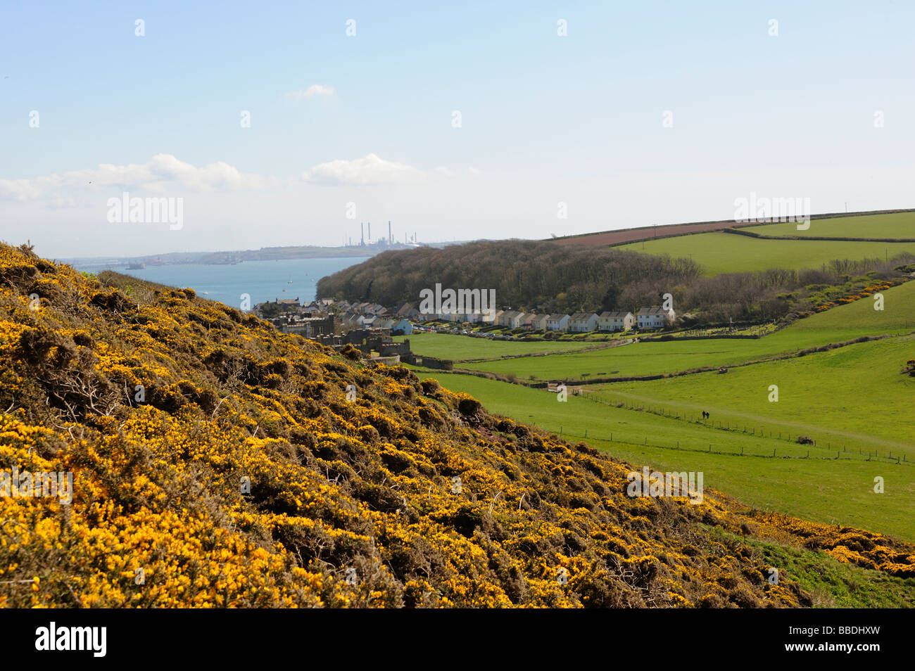 The village of Dale,with Milford Haven oil refinery in the distance,Pembrokeshire,west Wales,UK Stock Photo