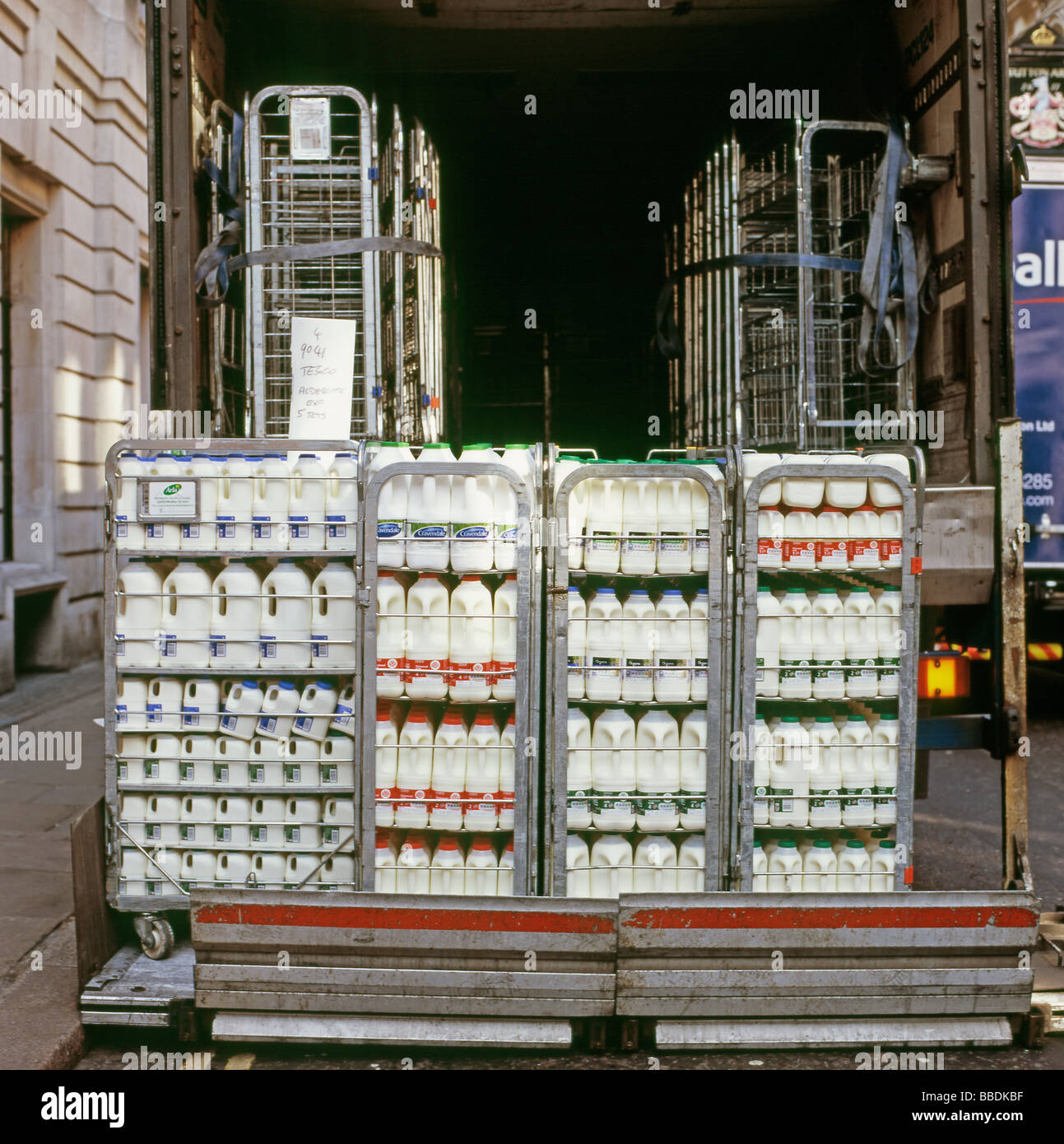 Rear view of plastic milk bottles on the back of a Tesco supermarket milk delivery van lorry in Clerkenwell London England UK   KATHY DEWITT Stock Photo
