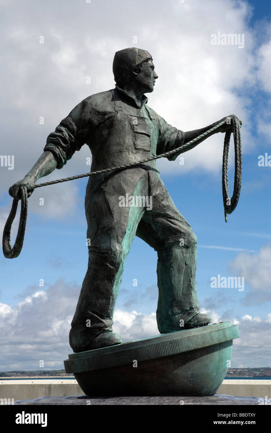 Staute of fisherman casting his line to shore to commemorate fishermen lost at sea, Newlyn Cornwall Stock Photo