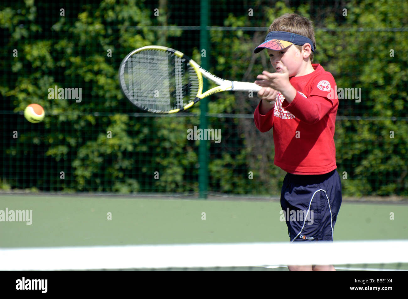 A young boy playing tennis Stock Photo - Alamy