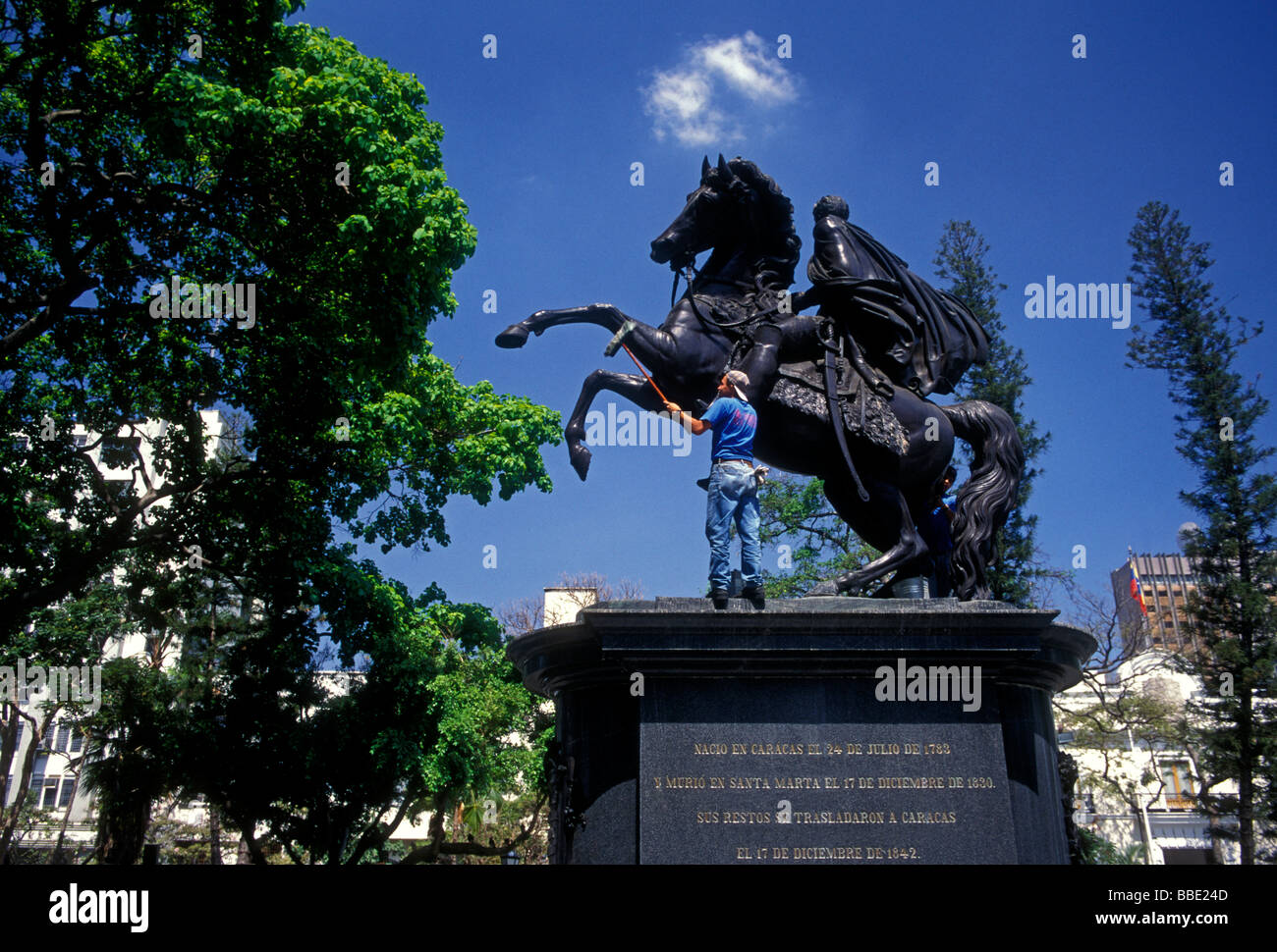 Venezuelan man, washing, cleaning, equestrian statue, statue of Simon Bolivar, Simon Bolivar, Plaza Bolivar, city of Caracas, Venezuela Stock Photo