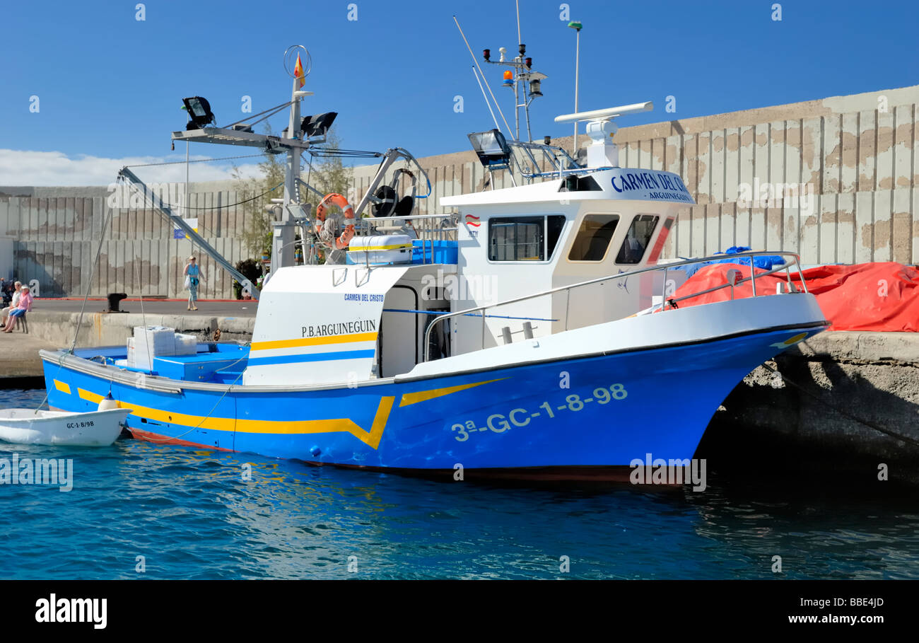A fishing boat in harbour of small coastal village of Arguineguin. Gran Canaria, Canary Islands, Spain, Europe. Stock Photo