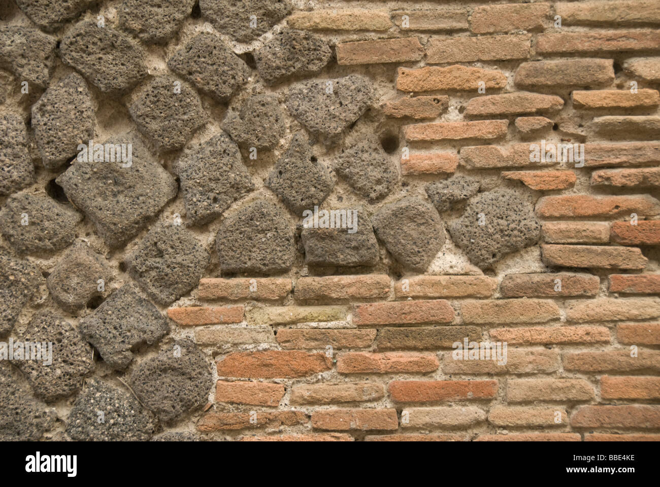 Detail of a wall in Pompeji, Italy. The materials are volcanic stone and brick. Stock Photo