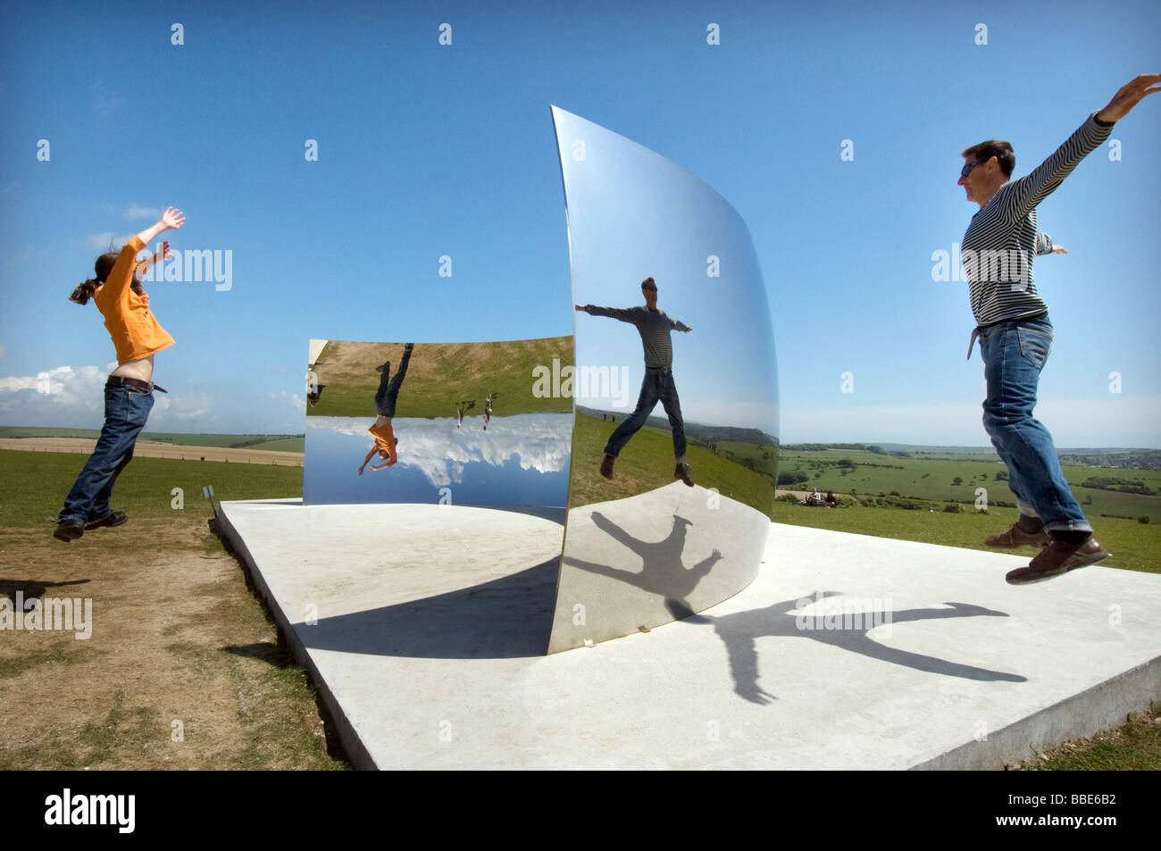Enjoying reflections in the C Curve by sculptor Anish Kapoor on the South Downs near Clayton for the 2009 Brighton Festival Stock Photo
