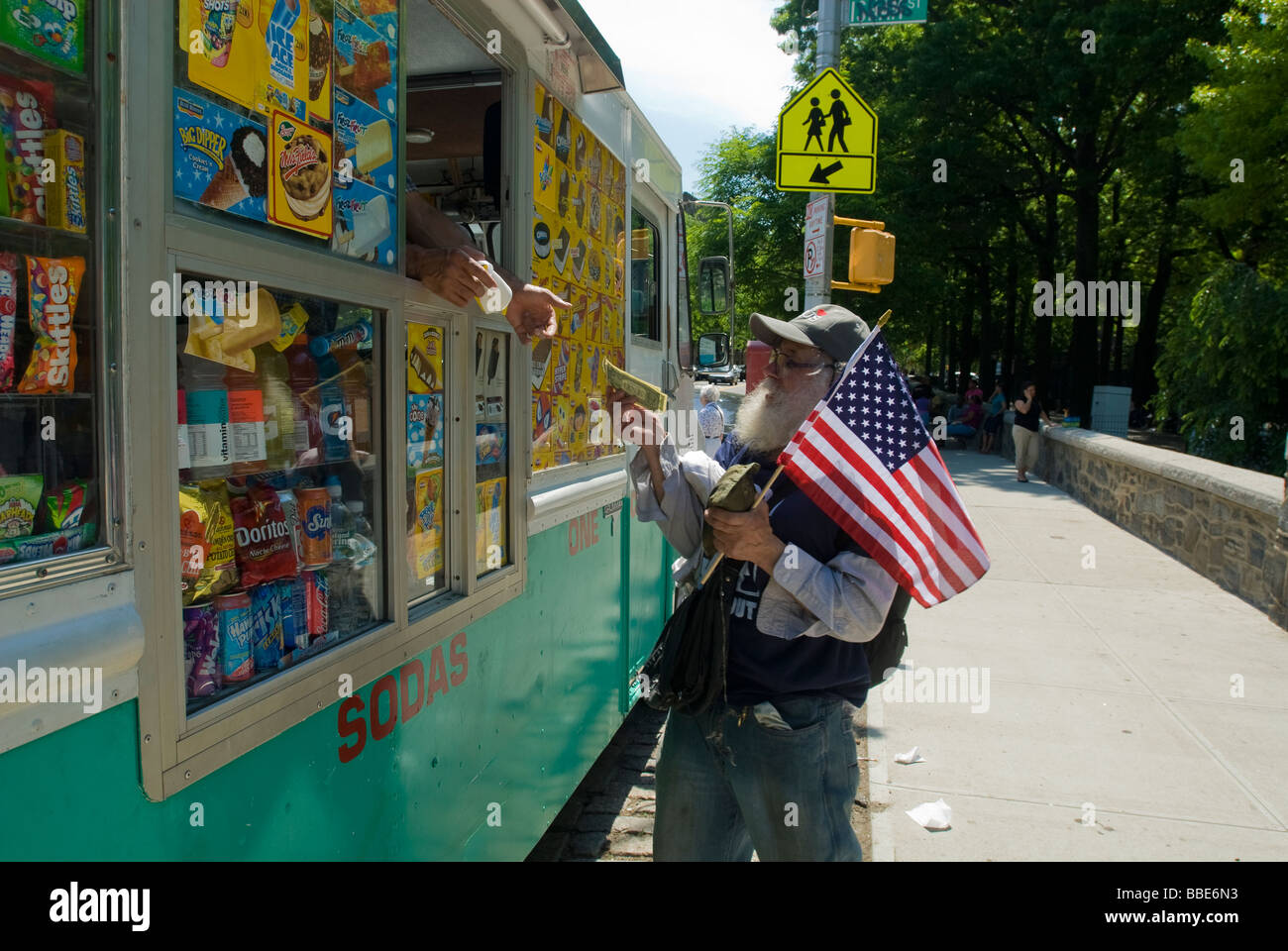 A spectator buys ice cream after the Memorial Day Parade in the upper Manhattan neighborhood of Inwood Stock Photo
