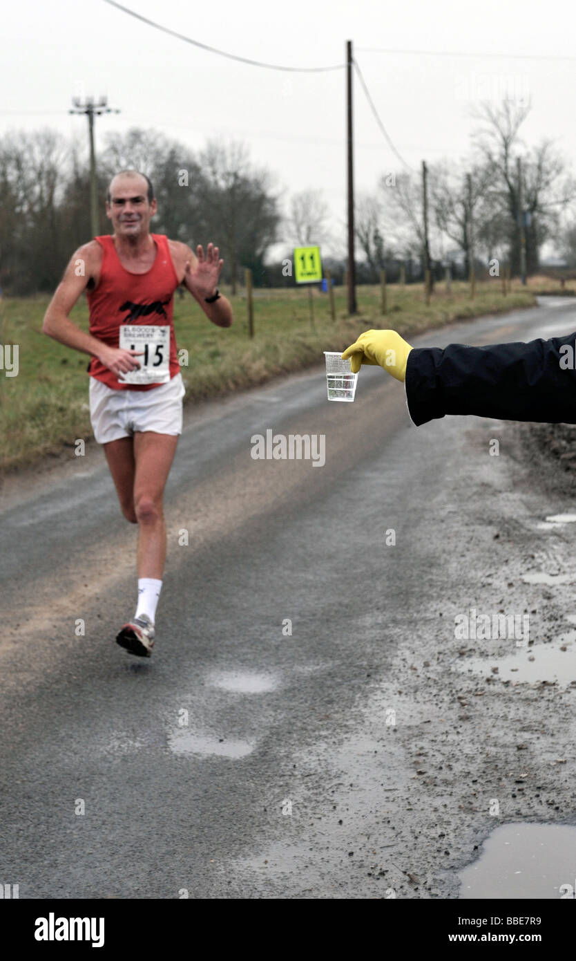 man about to pick up water as first man home for Bungay Black Dog running club at Great East Run on Sunday 15th Feb 2009 Stock Photo