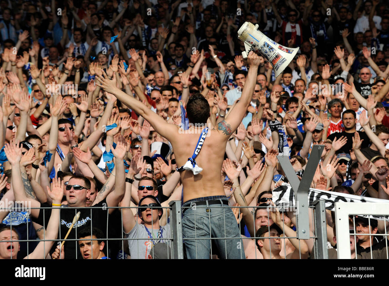 HSV-fan giving the beat with a megaphone, Hamburger SV fan block, Mercedes-Benz Arena, Stuttgart, Baden-Wurttemberg, Germany, E Stock Photo