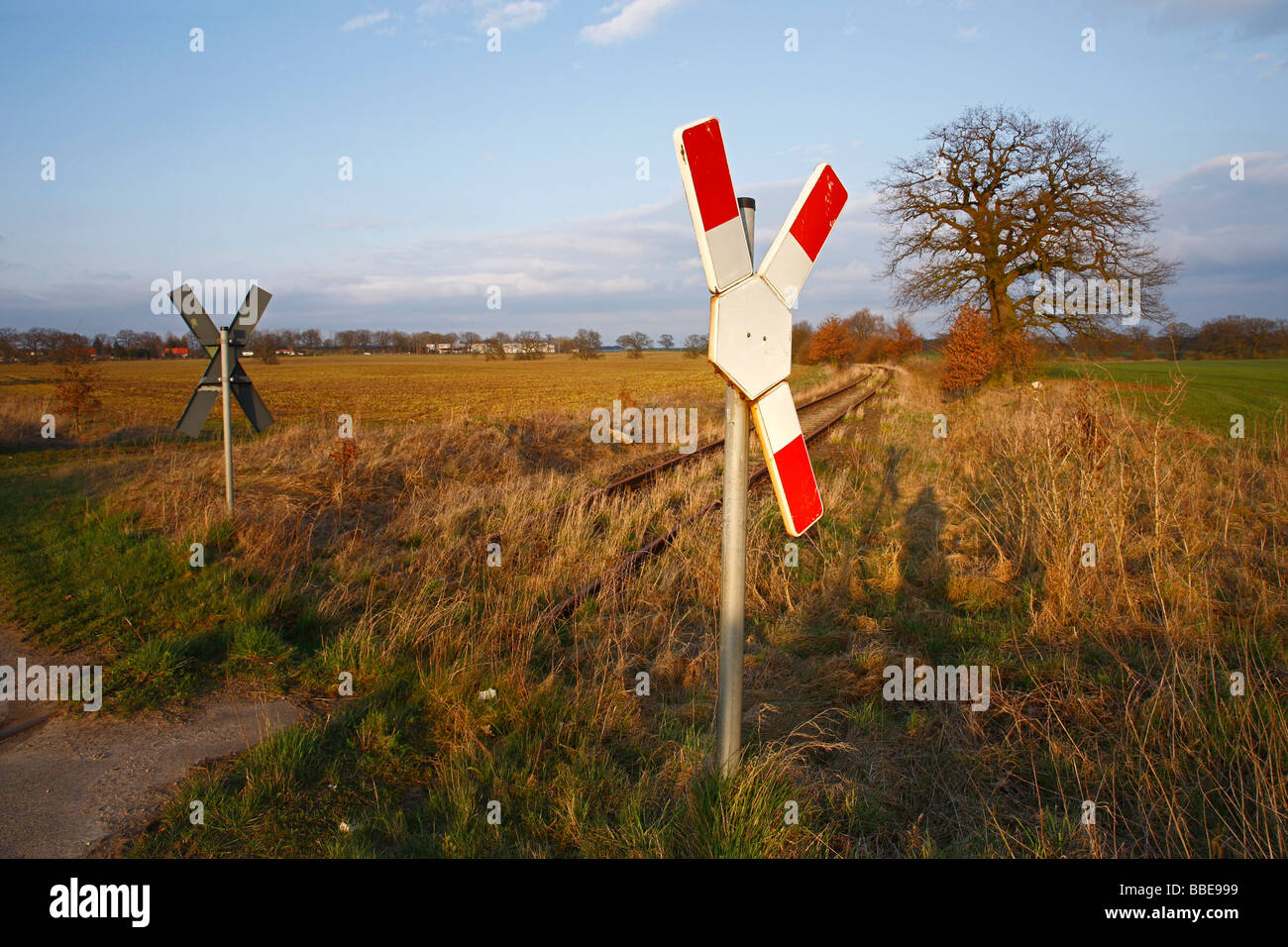Railway crossing sign and disused railway track Stock Photo