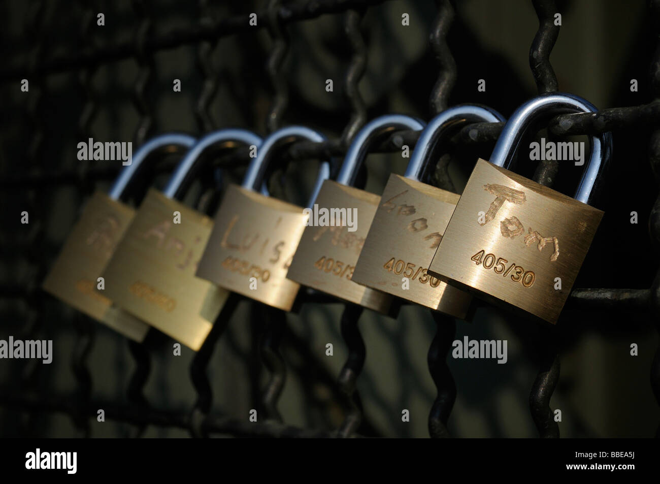 Padlocks as a symbol of friendship and love on the fence of the Hohenzollern bridge in Cologne, North Rhine-Westphalia, Germany Stock Photo