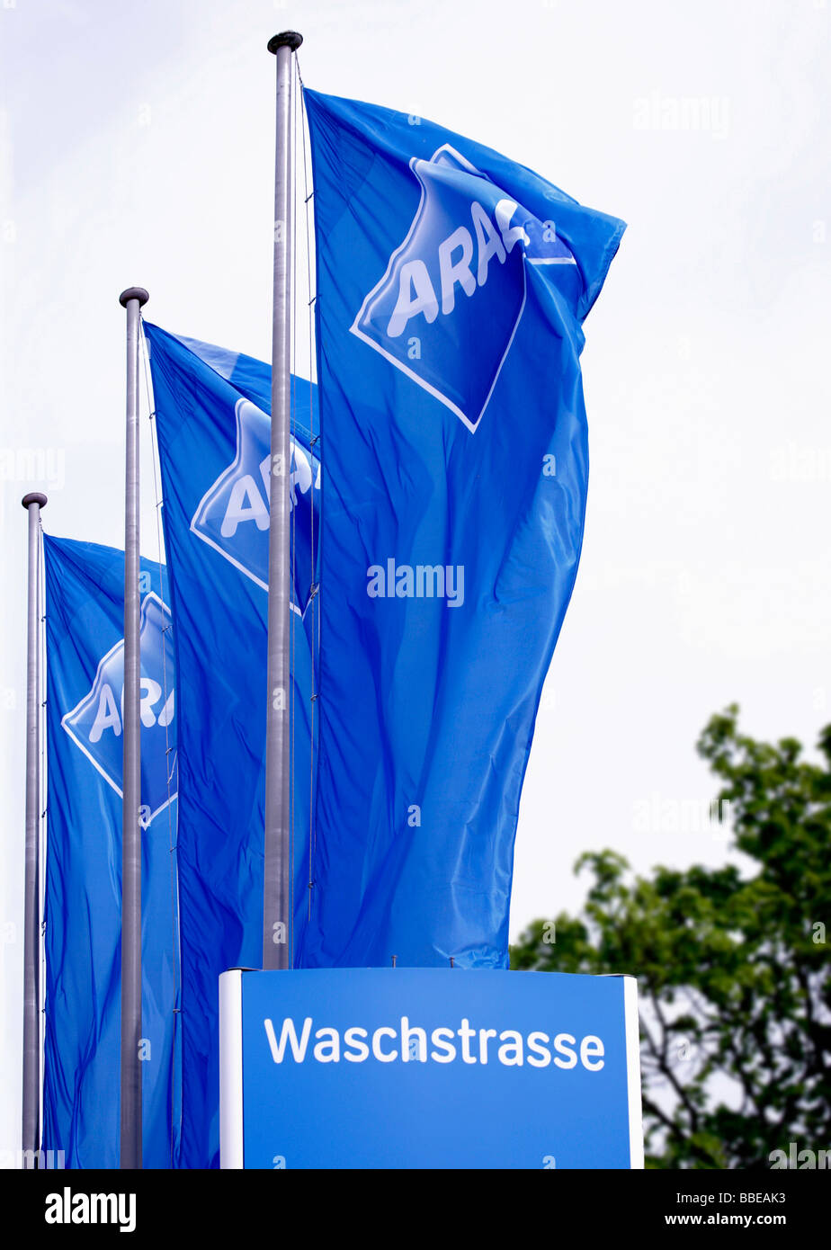 Aral flags blowing in the wind, at a car wash Stock Photo