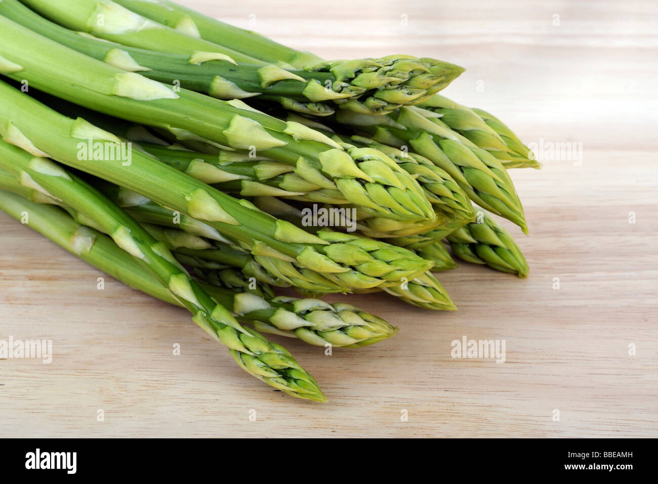 Green asparagus (Aspagurus), on cutting board Stock Photo