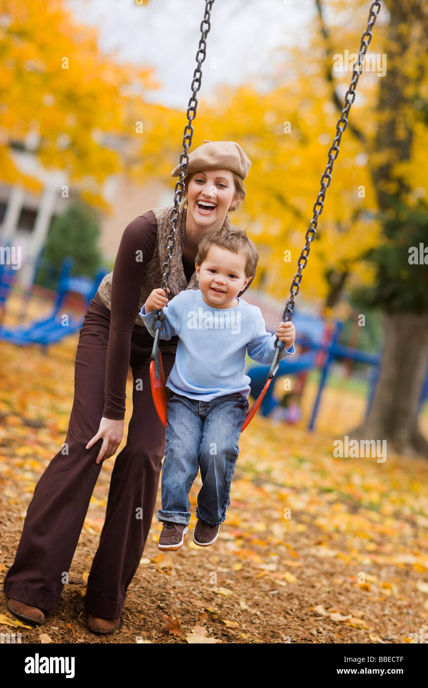 Mother Pushing Son on Swing in the Park, Portland, Oregon, USA Stock ...