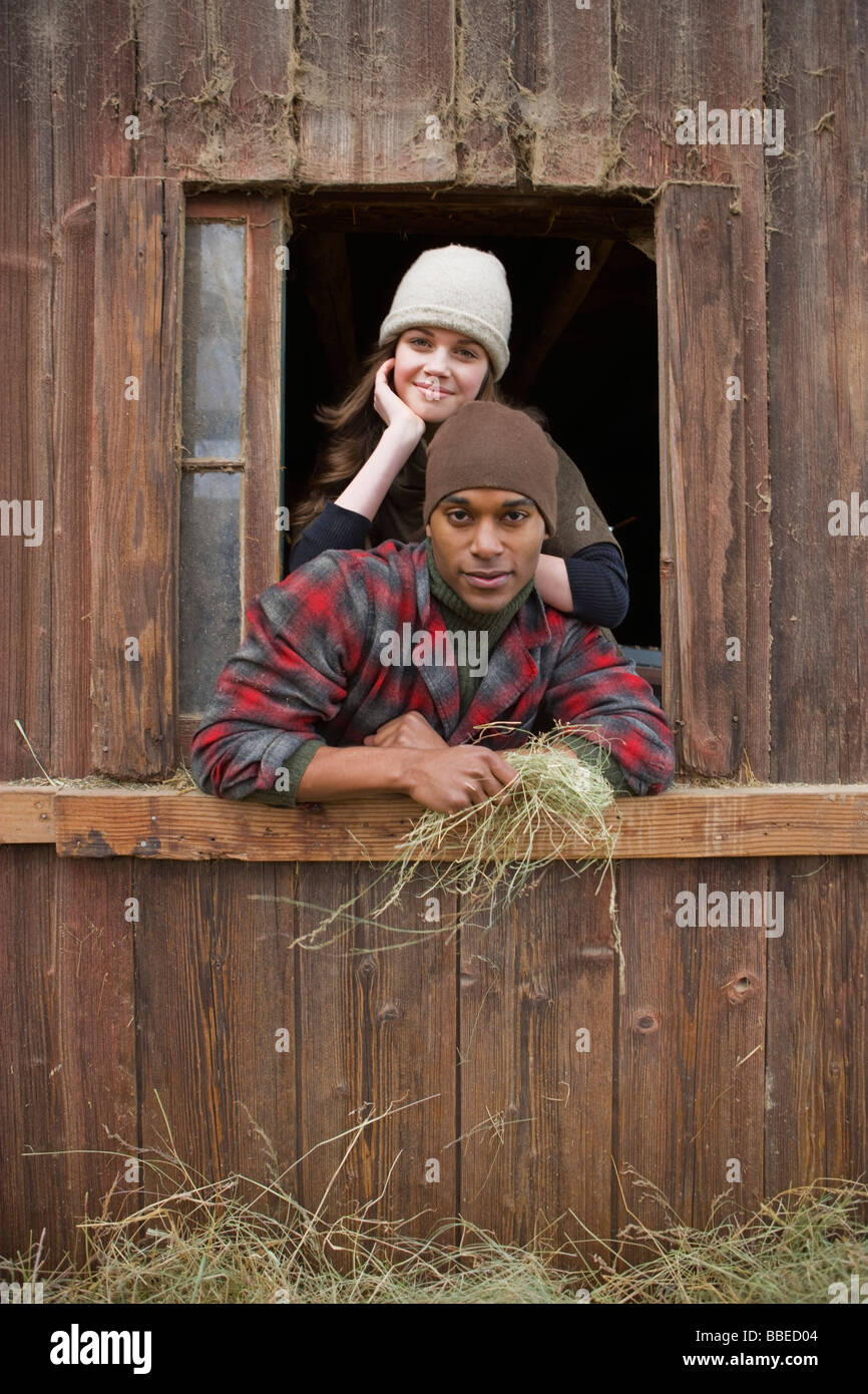 Portrait of Couple Leaning Out Barn Window on a Farm in Hillsboro