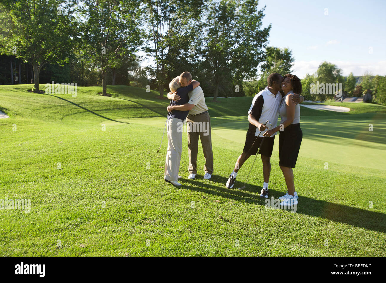 Couples Hugging on Golf Course, Burlington, Ontario, Canada Stock Photo