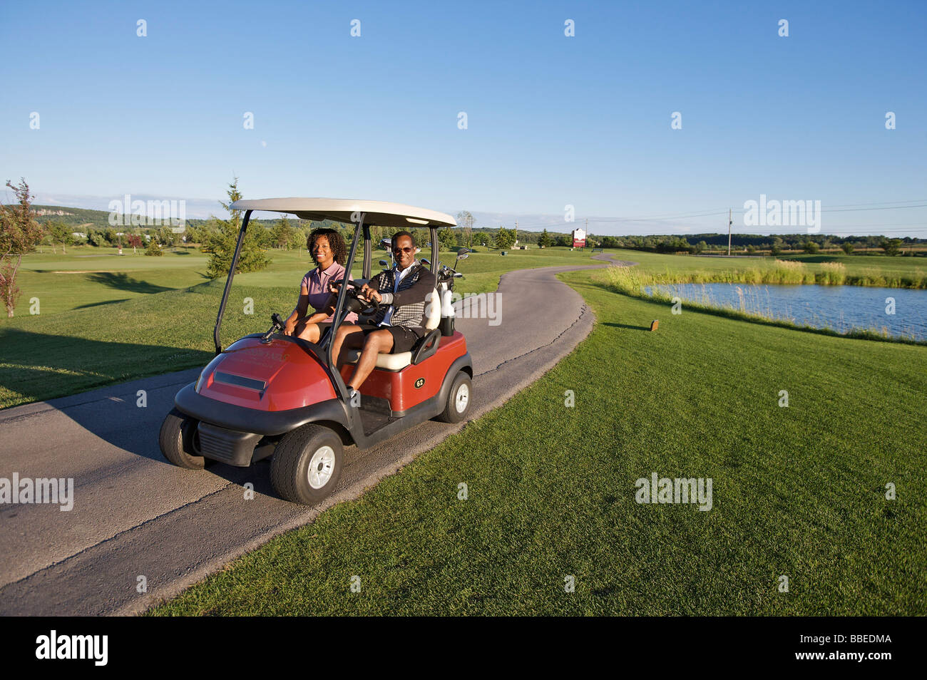 Couple in Golf Cart, Burlington, Ontario, Canada Stock Photo