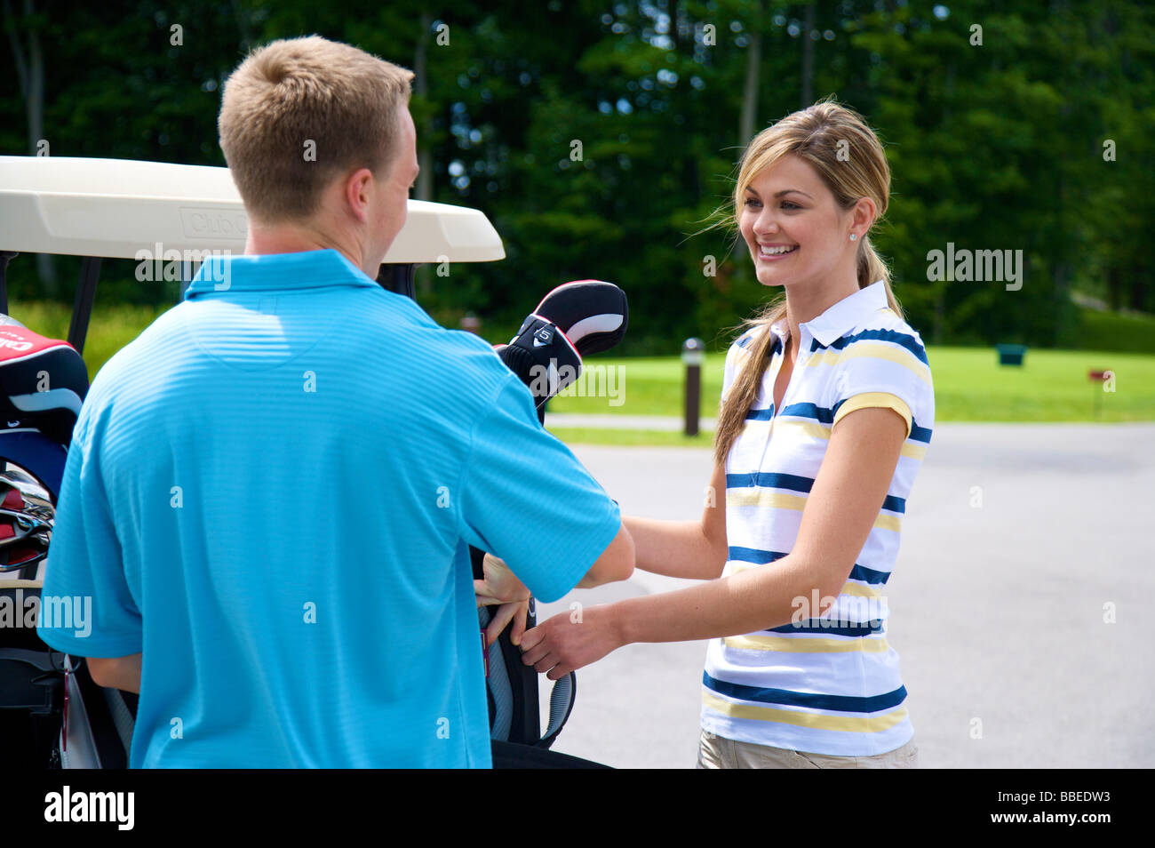 Couple Loading Golf Cart, Burlington, Ontario, Canada Stock Photo