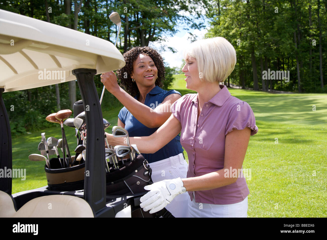 Women Unloading Golf Cart, Burlington, Ontario, Canada Stock Photo