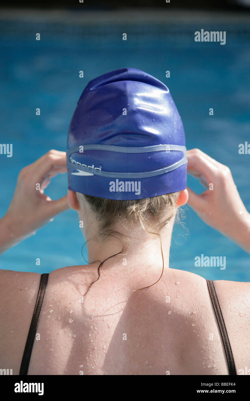 Woman by Swimming Pool with Bathing Cap and Goggles Stock Photo