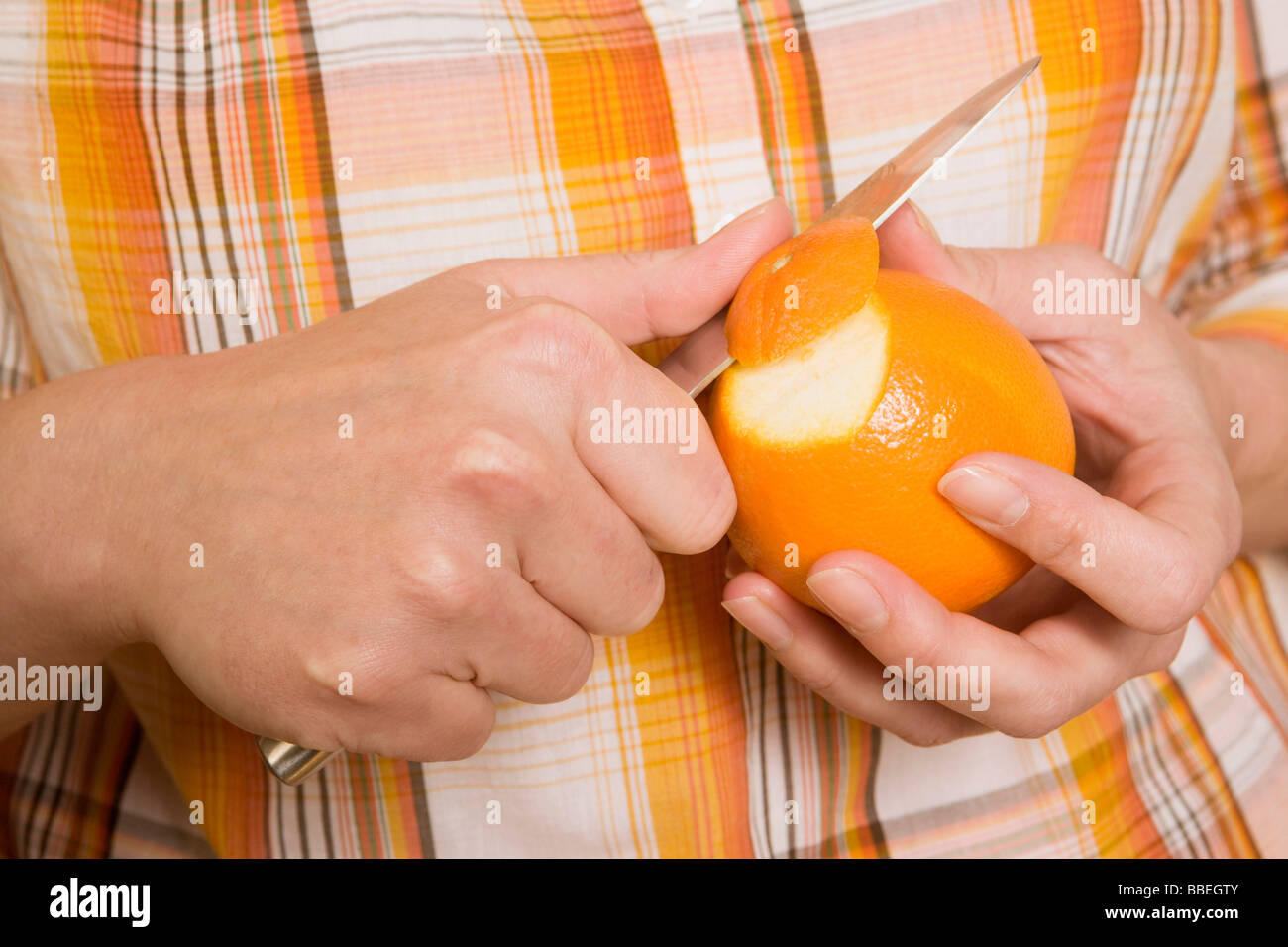Hands Peeling Orange Stock Photo - Alamy
