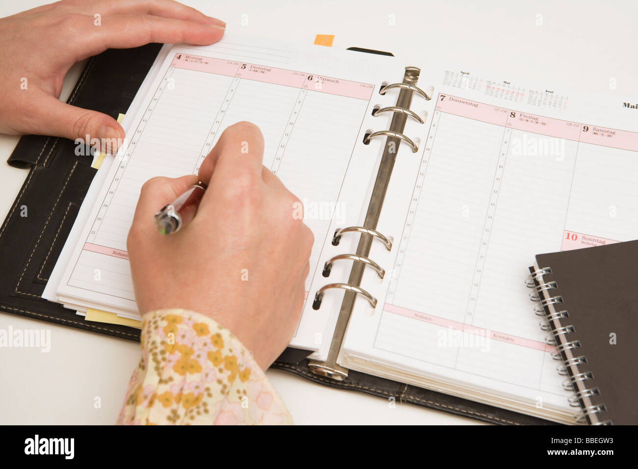 Hands Writing in Day Planner Stock Photo - Alamy
