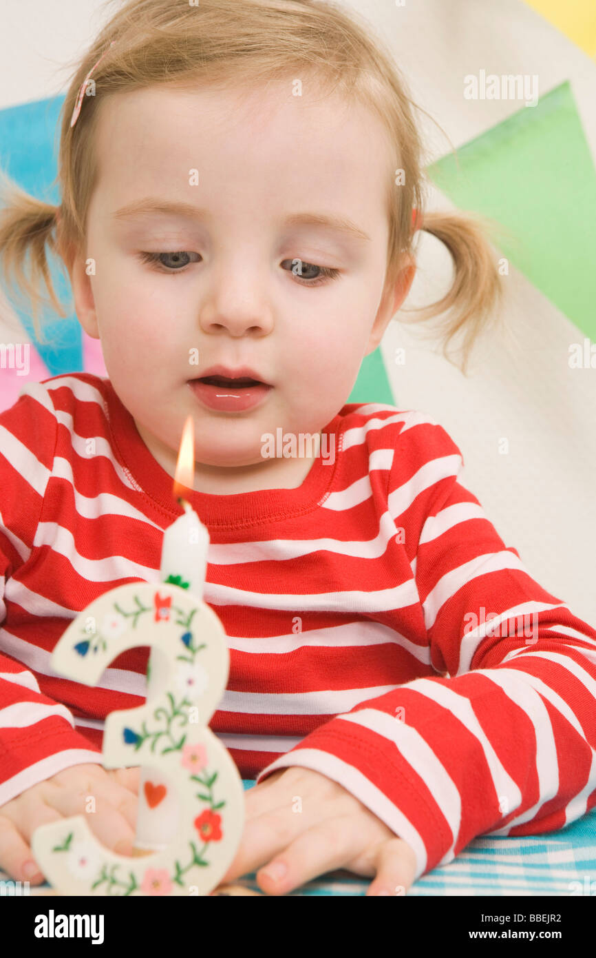 Little Girl Blowing Out Candle at a Birthday Party Stock Photo Alamy