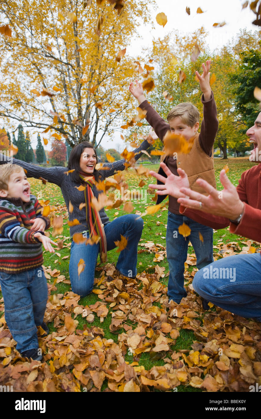 Family Throwing Autumn Leaves in the Air, Portland, Oregon, USA Stock Photo
