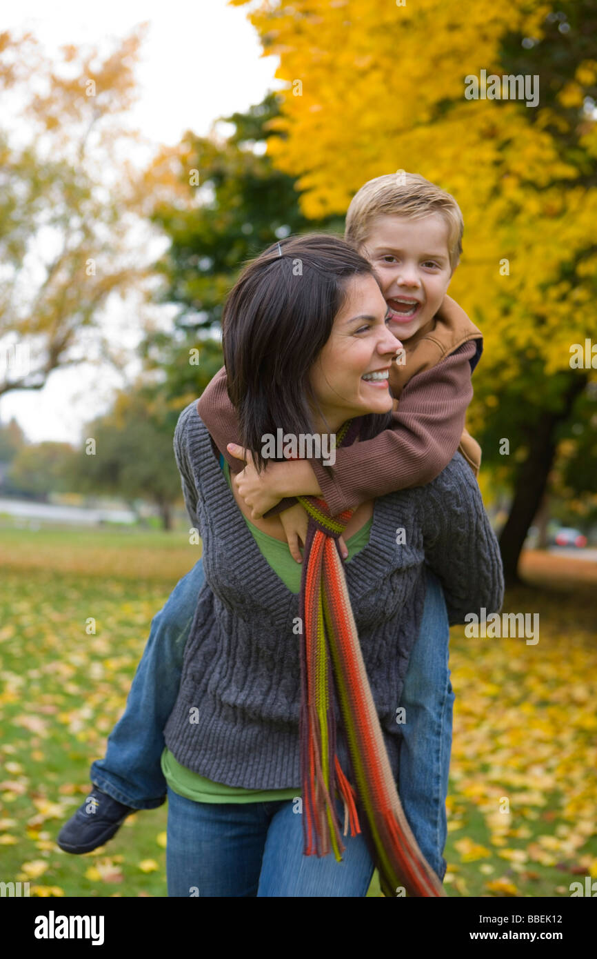 Little Boy Getting a Piggyback Ride From His Mother, Portland, Oregon, USA Stock Photo