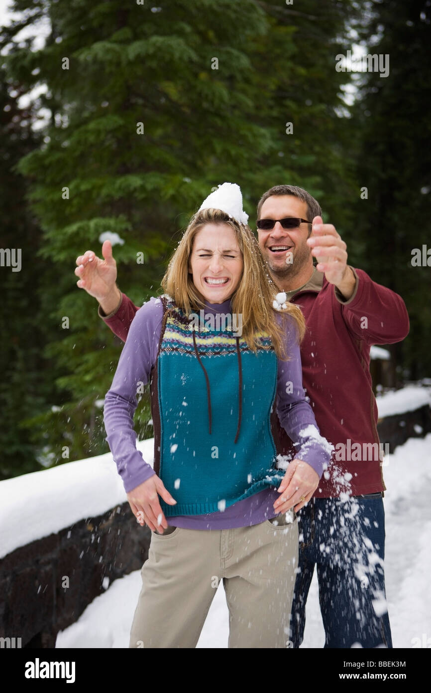 Man Dropping Snow on Wife's Head, Bend, Oregon, USA Stock Photo