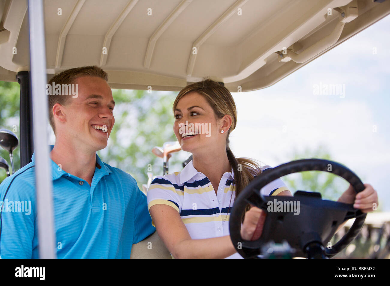 Couple in Golf Cart Stock Photo