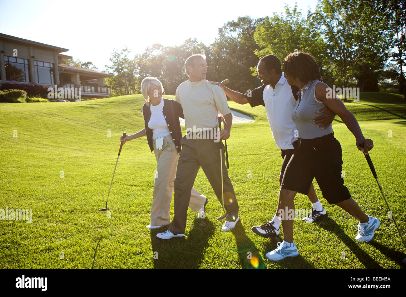 Couples on Golf Course Stock Photo