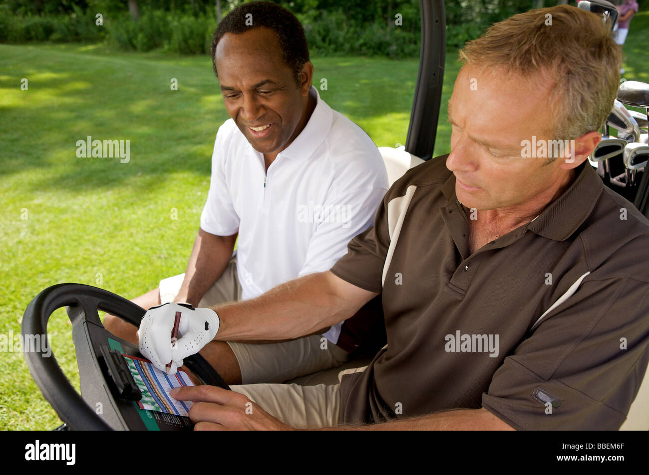 Golfers in Golf Cart with Scorecard, Burlington, Ontario, Canada Stock