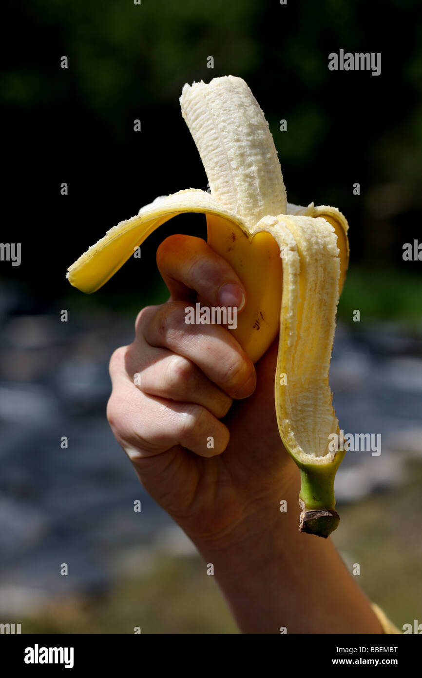 Young woman holding banana. Stock Photo