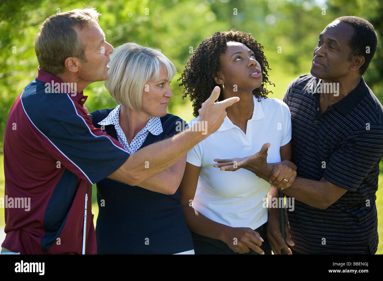 Couples Chatting on Golf Course Stock Photo
