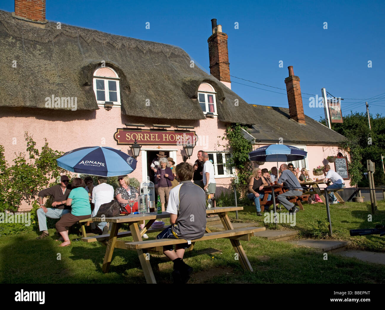 People sitting outside English country pub in summer Stock Photo
