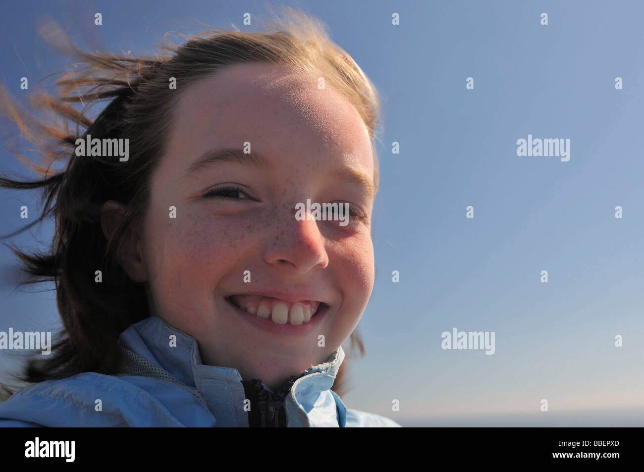 Portrait of a girl smiling with wind blowing in her hair Stock Photo