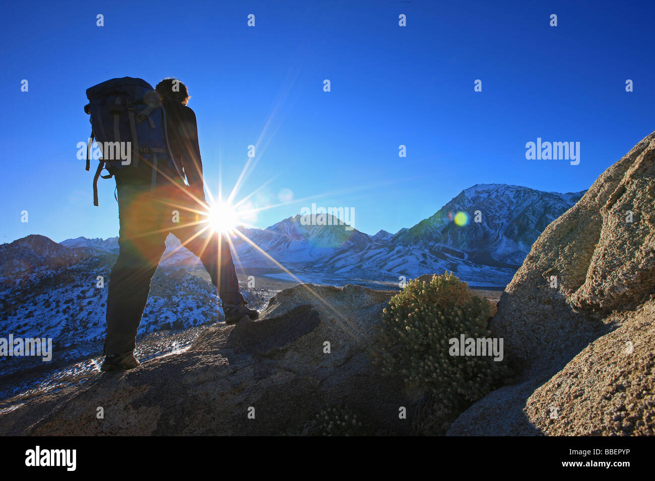 Hiker standing in bright sun, Sierra Nevadas, California Stock Photo