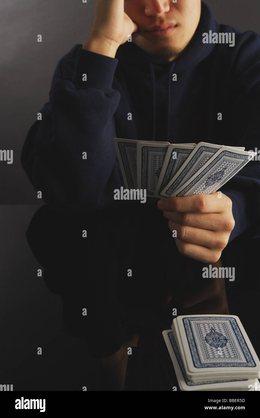 Man holding playing cards in his hands Stock Photo