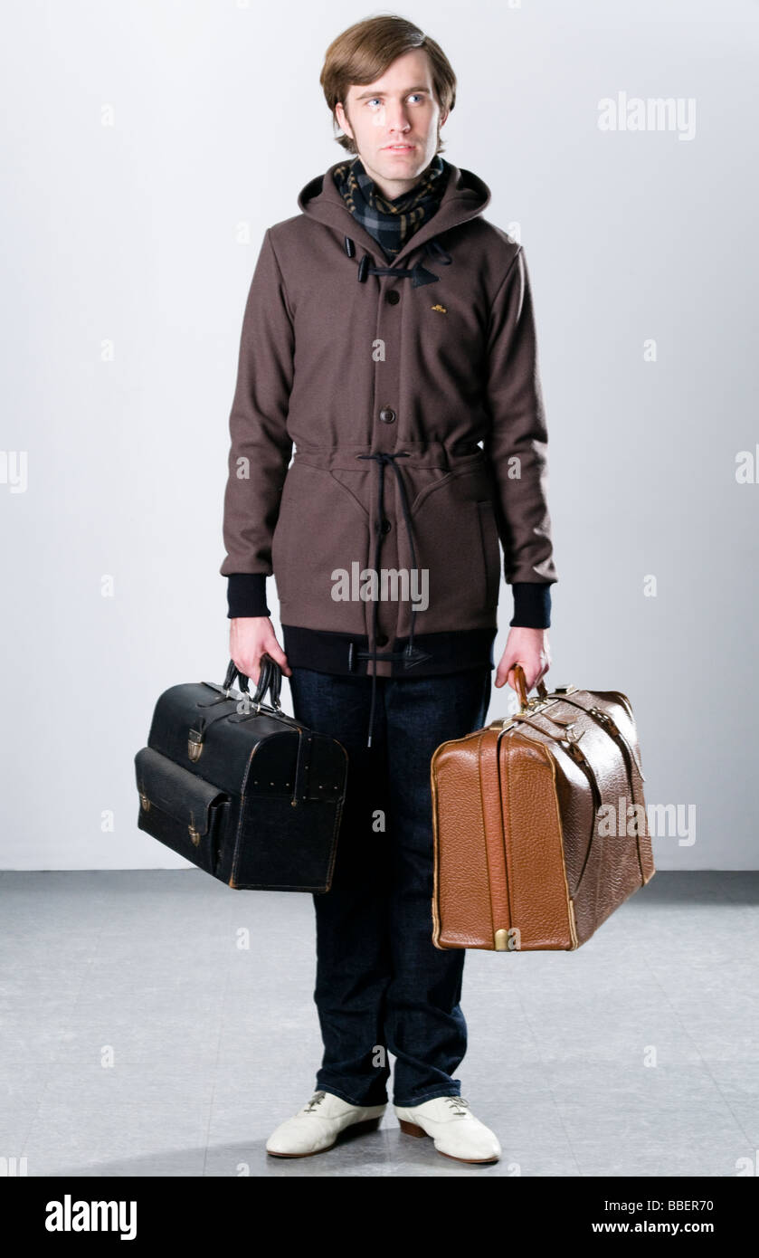 Man holding Luggage Stock Photo Alamy