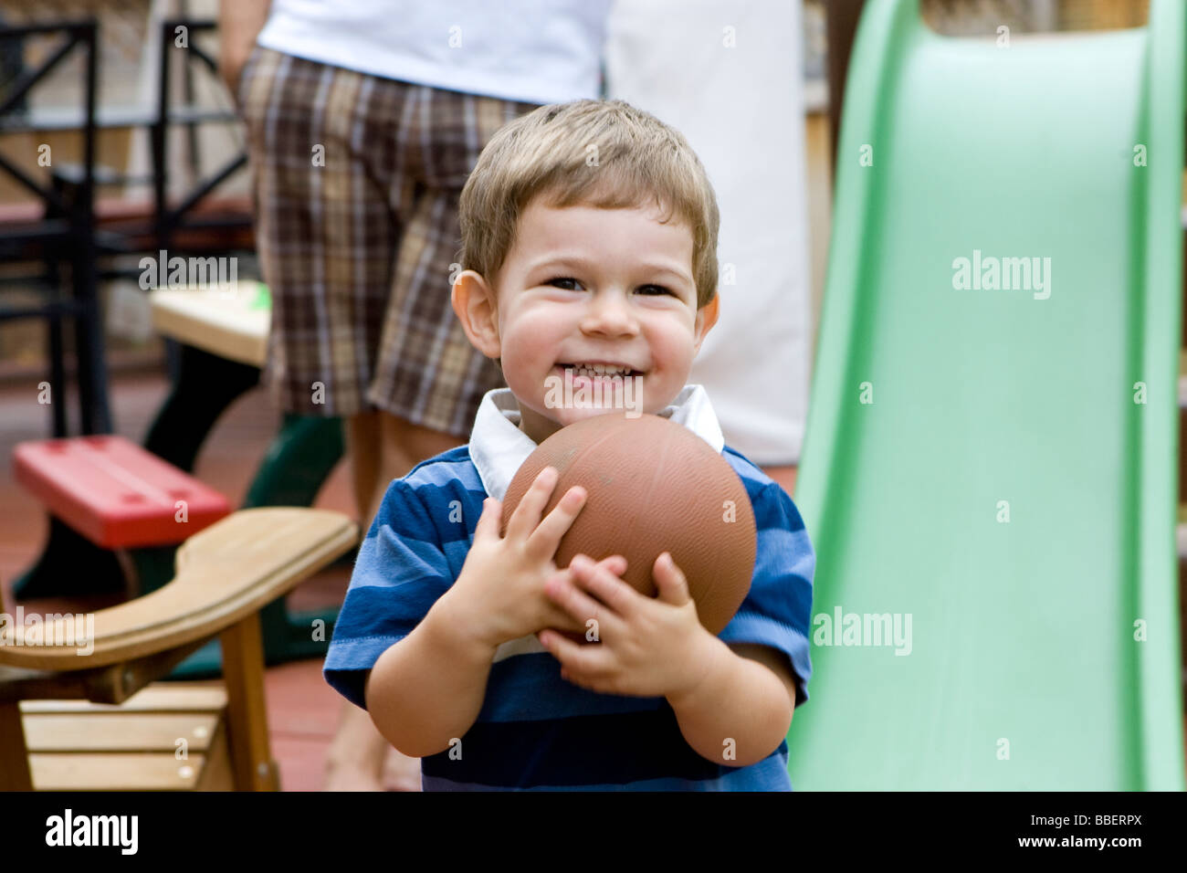 Two year old boy holding a ball, Milton, Ontario Stock Photo