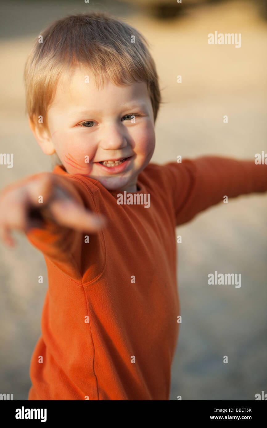 Laughing little boy in orange evening sunglight -- blurred background Stock Photo