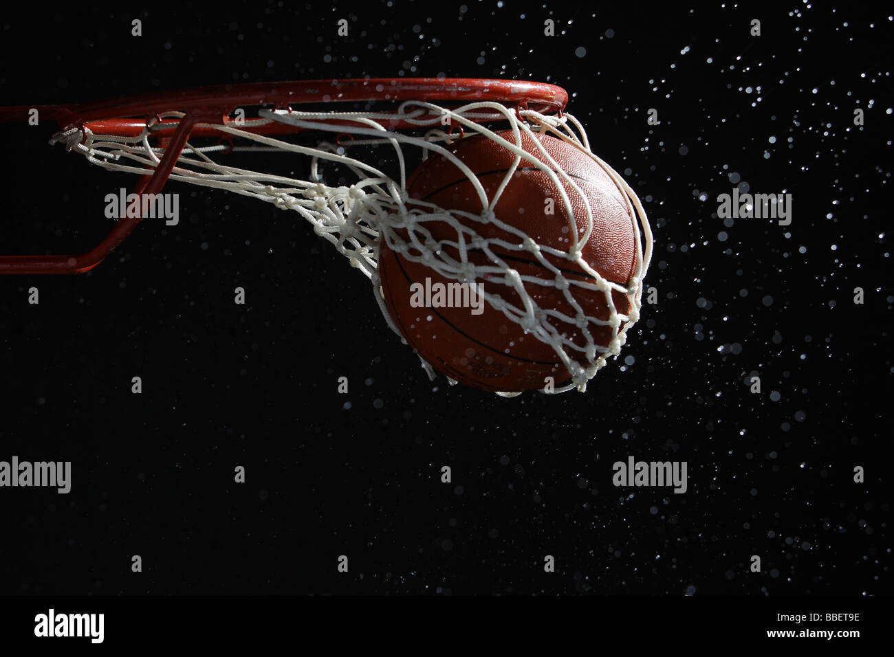 Basketball going through hoop Stock Photo Alamy